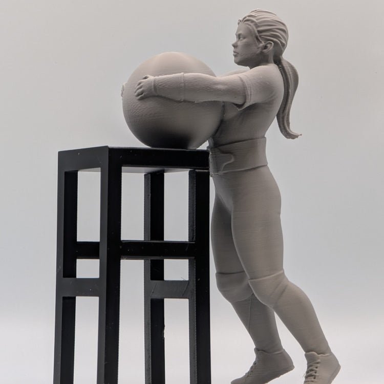 Strongwoman Lifting an Atlas Stone - Figures of strength